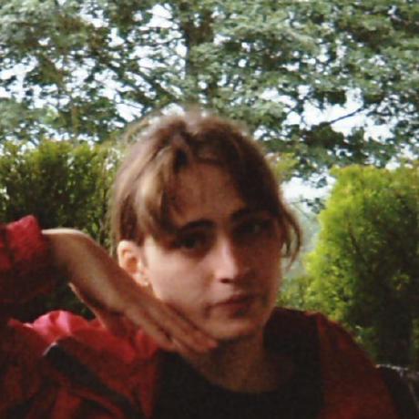 A photo of me, the photo has the quality of an old film camera, I'm wearing a red coat in a green area with trees and bushes in the background